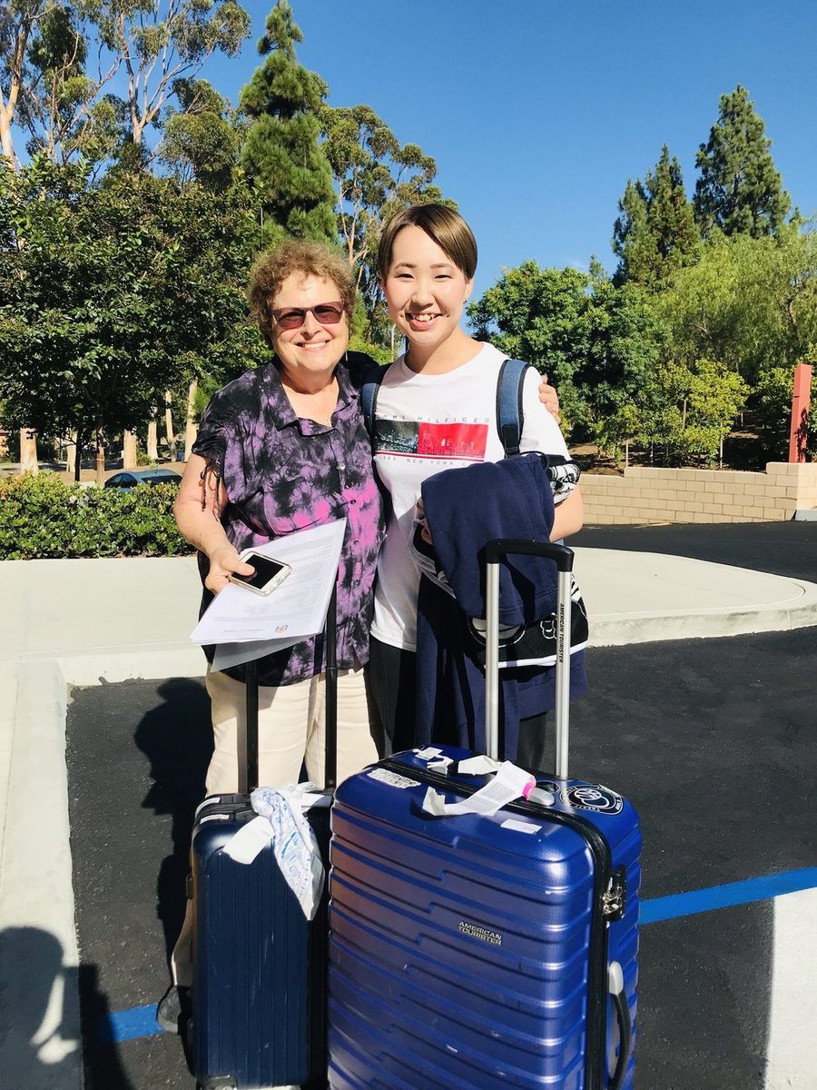 Host welcoming student with luggage on first day